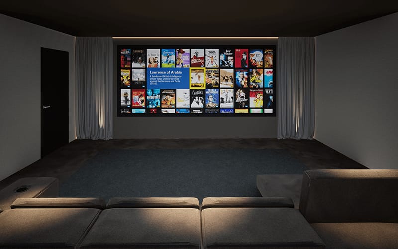 Home cinema room showing a media library on a large screen with tiered lounge seating