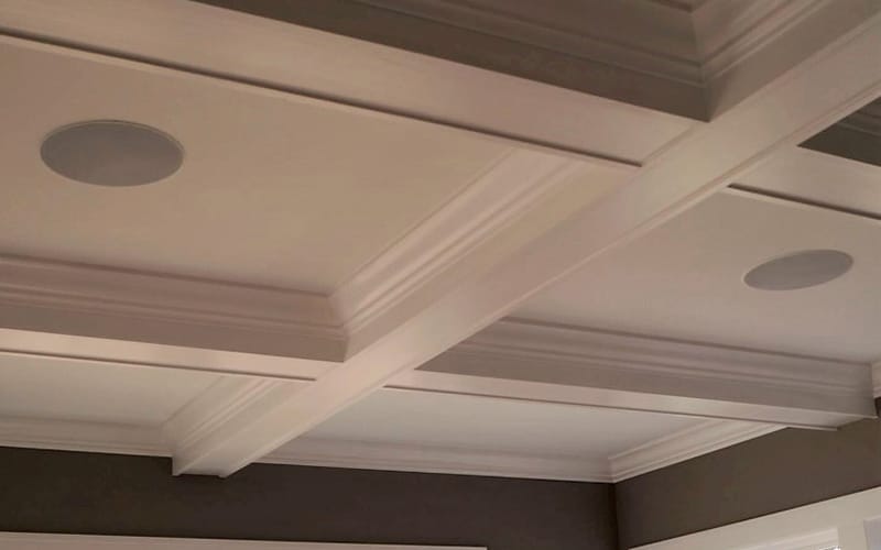 In-ceiling speakers installed flush into a coffered ceiling